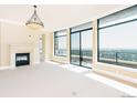 Spacious living room with large windows offering city views, a fireplace, and ample natural light at 8100 E Union Ave # 2201, Denver, CO 80237