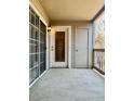 Covered balcony featuring sliding glass doors, a storage closet, and an outdoor light fixture at 9262 E Arbor Cir # H, Englewood, CO 80111