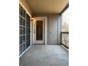 View of a covered balcony with sliding glass door and exterior storage closet at 9262 E Arbor Cir # H, Englewood, CO 80111