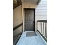 Close-up of a dark front door with a knocker and unit number, creating a welcoming entrance at 9262 E Arbor Cir # H, Englewood, CO 80111