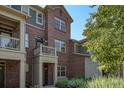 Inviting exterior view of a brick multi-story townhome with well-kept landscaping at 755 Roslyn St # 17, Denver, CO 80230