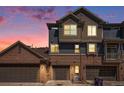 Charming townhome exterior with a brick and siding facade, complemented by a three-car garage at 755 Roslyn St # 17, Denver, CO 80230