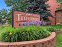 Exterior view of the Telluride community sign surrounded by lush greenery and colorful flowers at 451 Wright St # 11, Lakewood, CO 80228
