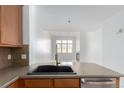Bright kitchen view highlights stainless steel appliances and an open layout to the living area at 15455 Canyon Rim Dr # 304, Englewood, CO 80112