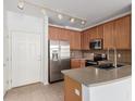 Efficient kitchen boasts stainless steel appliances, track lighting, and ample cabinet space at 15455 Canyon Rim Dr # 304, Englewood, CO 80112