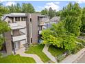 Aerial view of a modern three-story home featuring a brick facade, manicured lawn, and inviting outdoor spaces at 2420 S Gilpin St, Denver, CO 80210