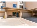 Exterior view of building featuring private entrance, garage parking, and stucco facade at 13351 W Alameda Pkwy # 203, Lakewood, CO 80228
