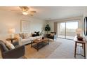 Bright living room featuring neutral paint, plush carpet, and sliding glass doors to a balcony at 13351 W Alameda Pkwy # 203, Lakewood, CO 80228