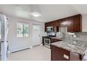 Modern kitchen featuring granite countertops, stainless steel appliances, and rich wood cabinetry at 4812 W 8Th Ave, Denver, CO 80204