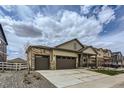Inviting home with a three-car garage and stone-accented covered porch at 4815 Cattle Cross Rd, Castle Rock, CO 80104