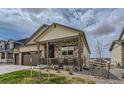 Inviting covered front porch offers charming curb appeal with decorative stone accents at 4815 Cattle Cross Rd, Castle Rock, CO 80104