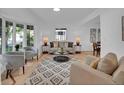 Bright living room with large windows, hardwood floors, and modern decor at 6359 S Locust Way, Centennial, CO 80111