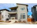 Charming two-story home with a red front door and cozy balcony at 1345 W 67Th Pl, Denver, CO 80221