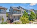 Attractive two-story home with a balcony, modern design, and a beautifully landscaped front yard at 1345 W 67Th Pl, Denver, CO 80221