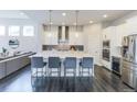 Stylish kitchen with a large center island, modern appliances, and seating at 1345 W 67Th Pl, Denver, CO 80221
