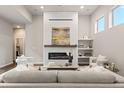 Cozy living room features a modern fireplace, built-in shelving, and comfortable seating at 1345 W 67Th Pl, Denver, CO 80221