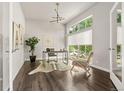 Bright home office with hardwood floors, large window, desk, and modern light fixture at 1345 W 67Th Pl, Denver, CO 80221