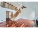 Spacious living room featuring hardwood floors, a staircase, and vaulted ceilings at 2121 S Troy Way, Aurora, CO 80014