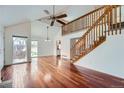 Spacious living room with hardwood floors and a wooden staircase at 2121 S Troy Way, Aurora, CO 80014