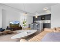 Bright living room featuring gray cabinets, modern lighting, and sleek, contemporary design elements at 1750 Wewatta St # 700, Denver, CO 80202