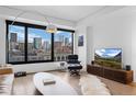 Stylish living room with expansive windows offering cityscape views, and contemporary decor and furnishings at 1750 Wewatta St # 700, Denver, CO 80202