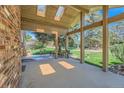Spacious covered back patio with skylights, offering a perfect outdoor retreat overlooking the backyard at 8164 Flower Cir, Arvada, CO 80005