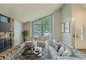 Bright living room with a brick fireplace, a large window, and stylish furnishings, creating a comfortable space at 8164 Flower Cir, Arvada, CO 80005