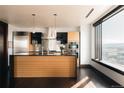 Bright, modern kitchen featuring stainless appliances, black countertops and a wood island at 1133 14Th St # 1820, Denver, CO 80202