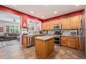 Modern kitchen features an island, stainless steel appliances, and eat in bar at 860 Bristle Pine Cir # A, Highlands Ranch, CO 80129
