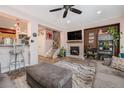Open living area boasts a fireplace, large TV, and seamless flow into the kitchen at 860 Bristle Pine Cir # A, Highlands Ranch, CO 80129