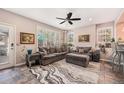 Inviting living room with plush seating, a ceiling fan, and plenty of natural light at 860 Bristle Pine Cir # A, Highlands Ranch, CO 80129