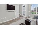 Inviting living room with wood floors, a modern front door, and a mounted TV at 19629 W 93Rd Dr # C, Arvada, CO 80007