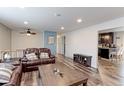Cozy living room with plush leather sofas, wood floors, and an open layout at 10679 Union Way, Broomfield, CO 80021