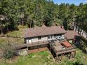 Backyard aerial view features a multi-level deck with seating and hot tub at 8422 S Ault Ln, Morrison, CO 80465