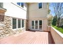 Outdoor deck showcases views of a backyard, stone accents, and bright windows at 13950 E Chenango Dr, Aurora, CO 80015
