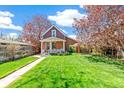 Quaint home featuring a well-manicured front lawn and a welcoming entrance with a cozy front porch at 3513 Quitman St, Denver, CO 80212