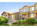 Inviting townhome exterior featuring well-maintained landscaping and a cozy front porch at 5562 W 72Nd Pl, Westminster, CO 80003