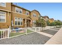 Attractive townhome exterior with a well-maintained front yard and a charming brick patio for outdoor enjoyment at 3668 Pecos Trl, Castle Rock, CO 80109