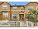 Charming home with a brick patio, white picket fence, and well-maintained landscaping at 3668 Pecos Trl, Castle Rock, CO 80109