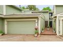 Charming townhouse with a two-car garage, quaint courtyard entry, and fresh exterior paint at 2840 S Kenton Ct, Aurora, CO 80014