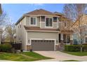 Beautiful two-story home featuring a large two-car garage, manicured lawn and stone accents at 15960 W 62Nd Dr, Arvada, CO 80403