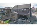 Home's back with patio, fire pit, and artificial turf at 1781 Chestnut Ave, Erie, CO 80516