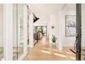 Bright foyer with hardwood floors, modern lighting, and a clear view of the staircase at 99 S Albion St, Denver, CO 80246