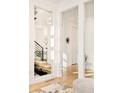 Hallway featuring hardwood floors, modern design, and access to multiple rooms at 99 S Albion St, Denver, CO 80246
