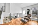 Inviting foyer featuring hardwood floors, elegant chair, and staircase leading to the main living area at 5183 Durham Ct, Denver, CO 80239