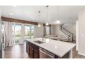 Modern kitchen open to the living area, featuring an island and access to the outdoor patio at 22921 E Union Ave, Aurora, CO 80015
