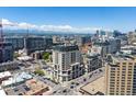 A vibrant aerial view showcasing the community's architectural design against the backdrop of Denver's skyline and mountains at 975 N Lincoln St # 3H, Denver, CO 80203