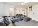 Spacious living room with open floor plan leading to dining area and kitchen at 178 Blue Bonnet Dr, Brighton, CO 80601