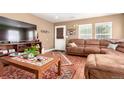 Inviting living room with comfortable seating, a cozy rug, and natural light, creating a warm atmosphere at 3505 Dinosaur St, Castle Rock, CO 80109