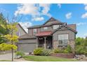 Beautiful home featuring a well-maintained lawn, colorful flower beds, and stone accents at 11961 S Saunter Ln, Parker, CO 80138